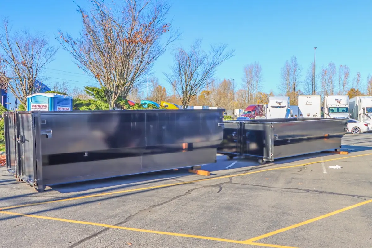 Professional dumpster rental service with roll-off container on residential driveway in Selma